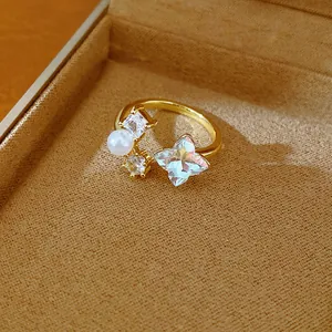 Detailed view of an elegant gold-plated open ring with a pearl and star-shaped zircon