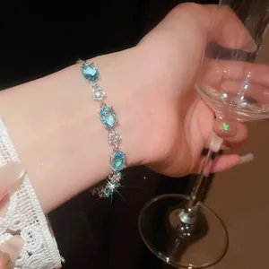 Elegant 18k gold plated bracelet with light blue oval zircons and floral details on wrist