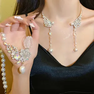 Exquisite silver-tone rhinestone pearl tassel necklace featuring unique wing-shaped design pendants