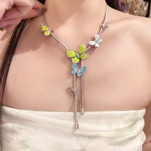 Detail view of silver butterfly necklace with colorful enamel and sparkling rhinestones