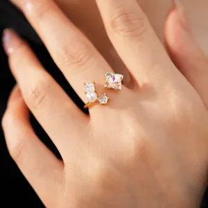 Macro detail of elegant gold open ring with iridescent flower zircon and white pearl