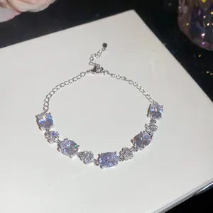 Detailed view of 18k gold plated bracelet with shimmering oval and flower zirconia stones