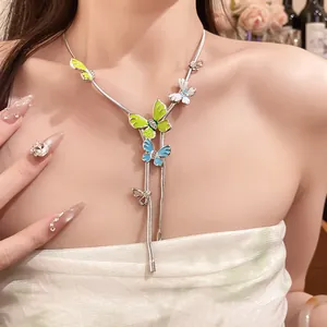 Detailed view of a sweet forest style butterfly necklace with enameled pendants on a model
