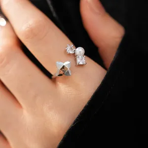 Close-up detail of open ring with zircon flower and pearl accent