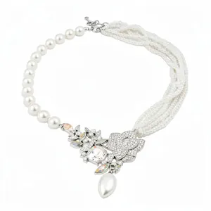 Elegant asymmetric pearl necklace with floral rhinestone pendant and teardrop pearl drop