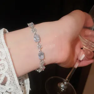 Detail view of elegant 18k gold plated bracelet featuring oval and flower zircon stones