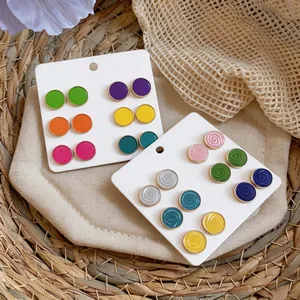 Elegant set of colorful round enamel stud earrings featuring solid and spiral designs