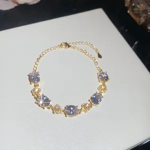 Macro view of elegant 18k gold plated bracelet featuring oval zircons and flowers