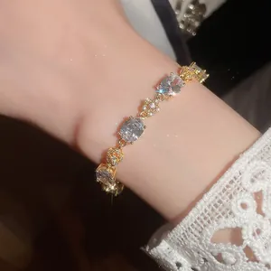 Elegant 18k gold-plated bracelet featuring sparkling oval zircons and delicate flower motifs
