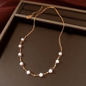 Detailed view of elegant 18k gold plated double-layer necklace with beads and pearls