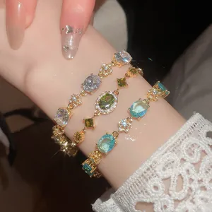 Close-up of 18k gold plated zircon bracelets featuring oval and flower shapes.