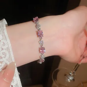 Close-up of elegant 18k gold plated pink oval zircon flower bracelet on wrist.