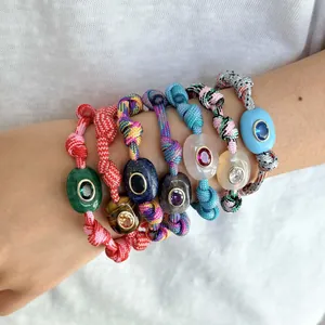 Close-up detail of colorful Bohemian woven bracelets with inlaid natural gemstones