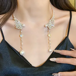 Close-up of elegant rhinestone choker with long pearl tassels on a model's neck