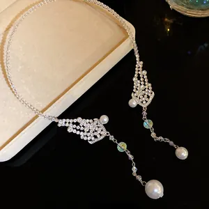 Detailed view of sparkly rhinestone beaded choker with elegant pearl pendants on jewelry box