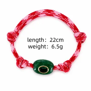 Detail of Bohemian braided rope bracelet with green natural stone and lucky eye bead