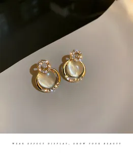 Exquisite gold-plated earrings with cat eye stones and G-shaped crystal detailing