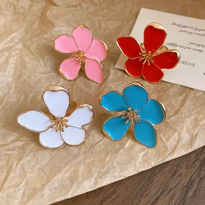 Detailed view of four colorful enamel flower-shaped adjustable rings in a set.