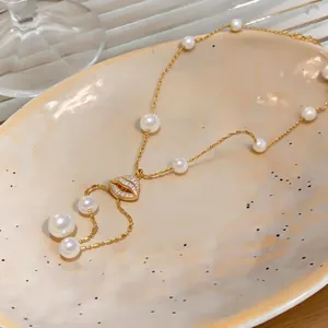 Elegant 18K gold-plated pearl necklace featuring a sparkling zircon lip pendant.