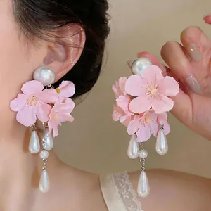 Elegant pink fabric flower drop earrings with white pearls and long teardrop tassels