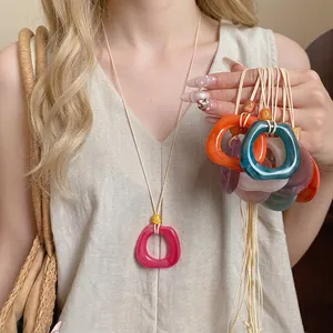 Minimalist resin ring cord necklace with geometric design on Asian model