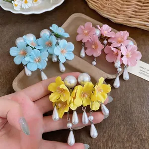 Detailed view of fresh fabric flower earrings with elegant pearl teardrop tassels in 3 colors