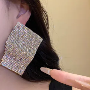 Macro view of sparkly iridescent rhinestone pavé on vintage square stud earrings