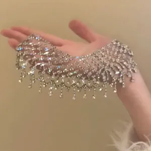 Macro detail of sparkly rhinestone fringe choker with delicate beaded lace pattern