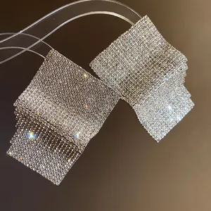 Exquisite detail of sparkling square rhinestone geometric earrings with luxury silver needles