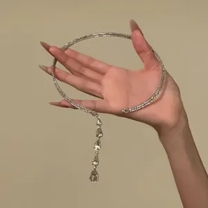 Hand holding silver-toned choker with cascading teardrop crystal pendants