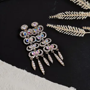 Macro view of exquisite gold chandelier earrings with multi-colored shimmering rhinestones