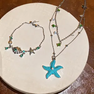 Elegant vacation-style jewelry set featuring zircon starfish and shell necklace and bracelet
