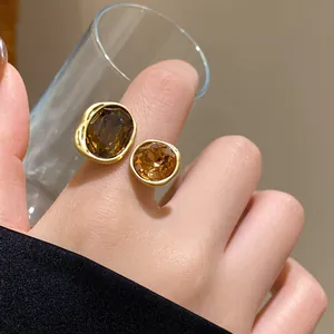 Close-up of vintage gold ring with amber crystals on hand