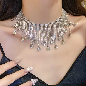 Close-up of elegant silver water-drop tassel necklace with sparkling rhinestones on model.