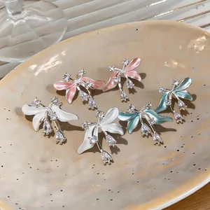 Gros plan de boucles d'oreilles fleurs avec émail et pierres de zircone cubique