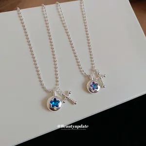 Elegant silver ball chain necklaces featuring circular star and cross pendants with crystals