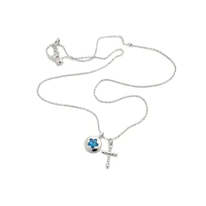 Elegant silver chain necklace with blue star crystal and textured cross charms on white