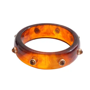 Vintage retro resin bangle with marbled amber finish and decorative round rivet studs
