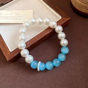 Close-up of elegant pearl and blue cat's eye stone beaded bracelet for women