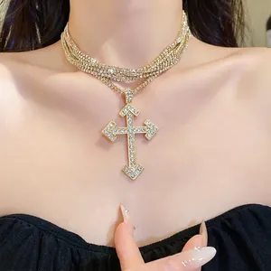 Elegant gold multi-layer necklace with a sparkling crystal cross pendant for women.