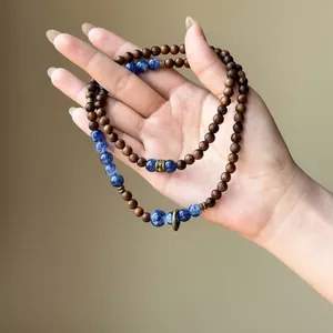 Detail view of retro wooden beads and blue stone bracelet in new Chinese style.
