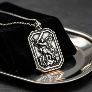 Detailed close-up showing the intricate St. Michael archangel engraving on a stainless steel pendant