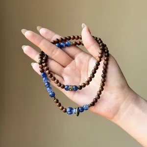 Detail of retro wooden beaded bracelet with blue marble stone beads in ethnic style