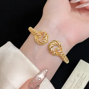 Detail view of 18K gold-plated twisted cuff bracelet with sparkling zircon stones