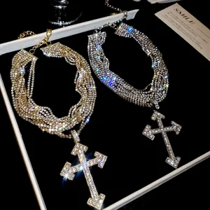 Detailed macro shot of multi-layer rhinestone cross necklace showcasing luxury sparkle.