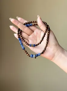 Vintage wood bead bracelet with blue marbled stone beads shown on hand, ethnic style