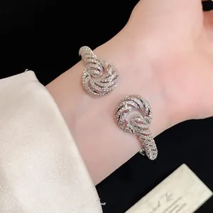 Detailed close-up of a luxury 18K gold plated zircon twisted open bangle bracelet