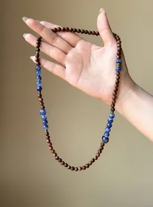 Detail of retro wood bead bracelet with blue marble stones and ethnic metal accents.