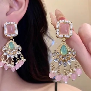 Vintage gold-tone earrings featuring pink square resin and teardrop green stones