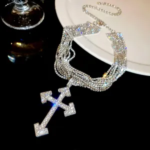 Detailed view of luxury multi-layer rhinestone choker with arrow cross pendant